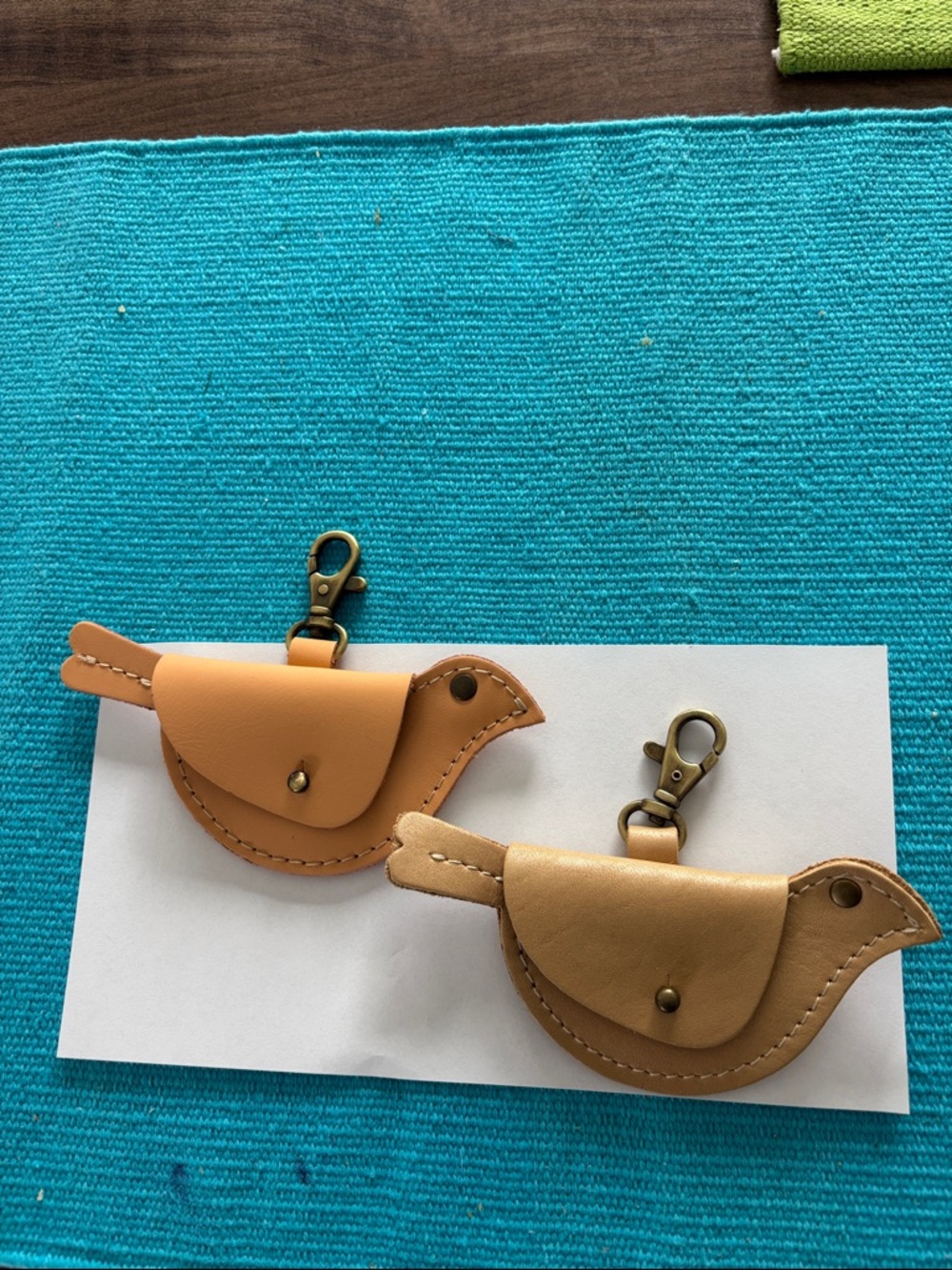 Portland Leather bird purse decoration. Mamet and champagne.
